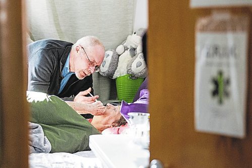 MIKAELA MACKENZIE / WINNIPEG FREE PRESS

Eric De Schepper cares (drips water into her mouth using a syringe) for his common-law wife, Katherine Ellis, who has pancreatic cancer and has opted for palliative care in Winnipeg on Friday, Feb. 17, 2023. He feels the health care system has failed them, as it took him going to the media to get any support in terms of home care workers. For Kevin story.

Winnipeg Free Press 2023.