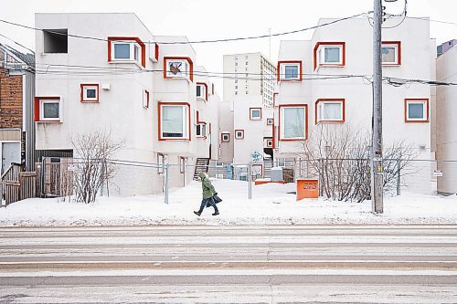 Mike Sudoma/Winnipeg Free Press
A pedestrian walks by a Manitoba Housing complex located at 575 Balmoral St Thursday afternoon
February 23, 2023 