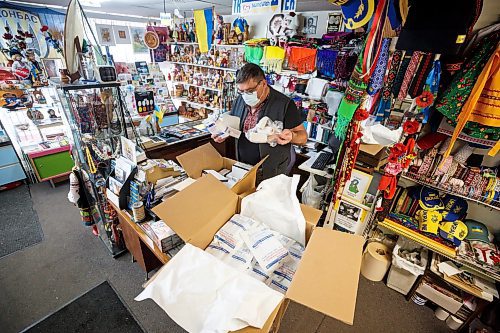 MIKE DEAL / WINNIPEG FREE PRESS
Ruslan Zeleniuk in his store, SVITOCH Ukrainian Export and Import at 621 Selkirk Avenue, between serving customers, puts together care packages filled with medical supplies for people in Ukraine. 
230223 - Thursday, February 23, 2023.