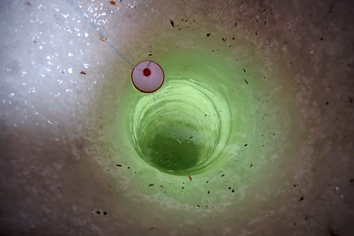 23022023
A look down the hole through three feet of ice in an ice-fishing shack on the Rivers Reservoir on Thursday. (Tim Smith/The Brandon Sun)