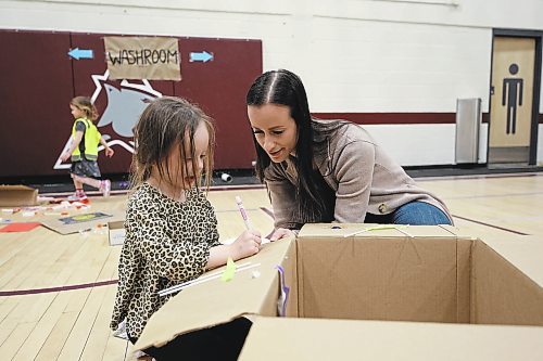 Emery Adams shares her cardboard box design with her mom, Nycolle Adams on Friday. (Geena Mortfield/The Brandon Sun)