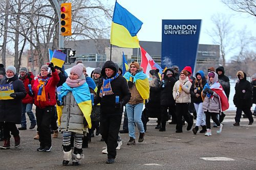 Participants of Friday's Ukrainian solidarity march turn onto Victoria Avenue from 18th Street, with a police convoy giving them free reign to take up the entire stretch of road. (Kyle Darbyson/The Brandon Sun)