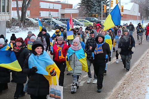 Participants of Friday's Ukrainian solidarity march turn onto Victoria Avenue from 18th Street, with a police convoy giving them free reign to take up the entire stretch of road. (Kyle Darbyson/The Brandon Sun)