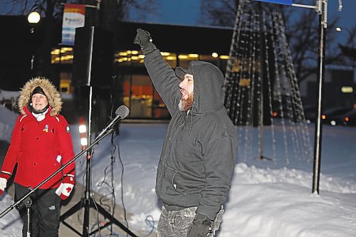 Vartan Davtian raises a defiant fist at Brandon City Hall Friday evening to show solidarity with people of Ukraine, who have endured a near constant bombardment from Russian military forces since the invasion began on Feb. 24, 2022. Davtian has seen this destruction first-hand, having spent time in Ukraine as a humanitarian aid volunteer. (Kyle Darbyson/The Brandon Sun)