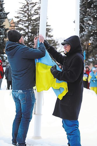 Brandon University communications director Grant Hamilton and president David Docherty raise the Ukrainian flag on campus Friday evening to highlight the school's solidarity with the European country, which is still contending with a destructive military invasion from Russia. (Kyle Darbyson/The Brandon Sun)  