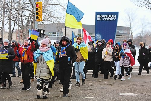 Participants of Friday's Ukrainian solidarity march turn onto Victoria Avenue from 18th Street, with a police convoy giving them free reign to take up the entire stretch of road. (Kyle Darbyson/The Brandon Sun)