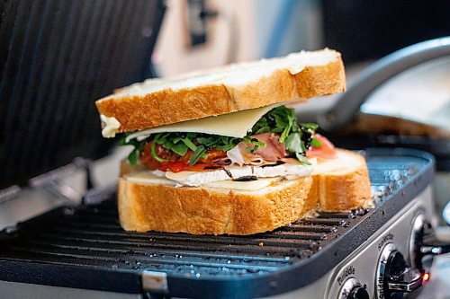 MIKAELA MACKENZIE / WINNIPEG FREE PRESS

Alex Svenne makes a brie and prosciutto grilled cheese sandwich at Buvette in the Village in Winnipeg on Thursday, Feb. 23, 2023. For Eva story.

Winnipeg Free Press 2023.