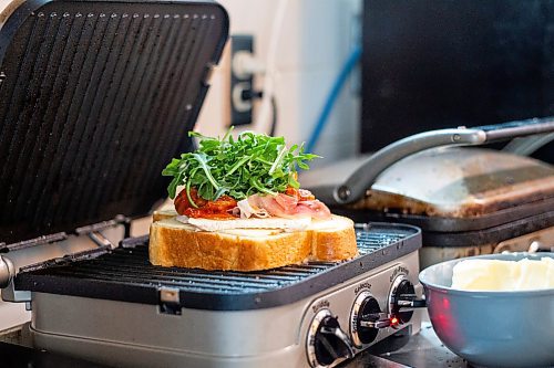 MIKAELA MACKENZIE / WINNIPEG FREE PRESS

Alex Svenne makes a brie and prosciutto grilled cheese sandwich at Buvette in the Village in Winnipeg on Thursday, Feb. 23, 2023. For Eva story.

Winnipeg Free Press 2023.