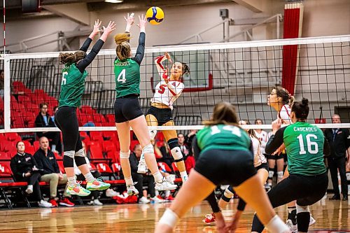 MIKAELA MACKENZIE / WINNIPEG FREE PRESS

U of W Wesmen Selva Planincic (5) spikes the ball and Fraser Valley Cascades Gabrielle Attieh (6) and Morgen Likness (4) block during a Canada west quarterfinal volleyball game at the Duckworth Centre in Winnipeg on Friday, Feb. 24, 2023. For Mike story.

Winnipeg Free Press 2023.