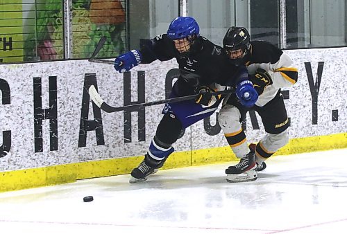 Interlake Lightning defenceman Jack Holmes (2) and Brandon under-17 AAA Wheat Kings forward Quinn Schutte battle for the puck during Brandon's 6-3 win over the Interlake Lightning at J&amp;G Homes Arena on Saturday afternoon. (Perry Bergson/The Brandon Sun)