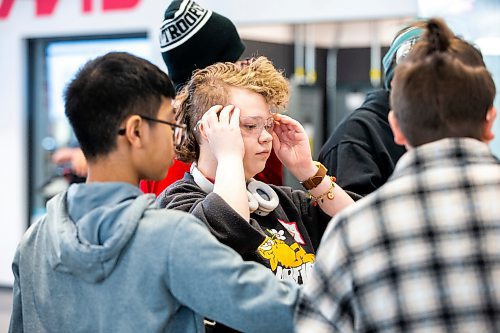 MIKAELA MACKENZIE / WINNIPEG FREE PRESS

Parc Richardson, 14, puts on safety glasses before starting on a project using the CNC routers at the first Gene Haas Manufacturing Bootcamp at Red River College Polytechnic in Winnipeg on Saturday, Feb. 25, 2023. The program gives youth in grades seven and eight an opportunity to check out 3D Printing, manufacturing and robotics. Standup.

Winnipeg Free Press 2023.