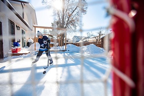 MIKAELA MACKENZIE / WINNIPEG FREE PRESS

Finn Batoon shoots pucks on his backyard rink in Winnipeg on Saturday, Feb. 25, 2023. When Finn moved to Canada from The Philippines in 2019, he was an avid basketball player, but Winnipeg&#x573; cold winters stopped him from shooting hoops year round and he took up hockey instead. He&#x573; now part of the U13 Raiders team. For &#x460;story.

Winnipeg Free Press 2023.