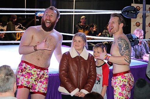 The Cloud 9 Wrestling tag team of Sammy Peppers and Bryce Bentley, known collectively as "Red Hot Summer," pose for photos with members of the audience at The Great Western Roadhouse following their Saturday evening match against The Cannon Corporation. (Kyle Darbyson/The Brandon Sun)  