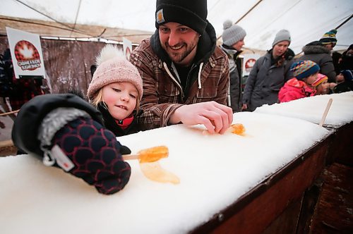 JOHN WOODS / WINNIPEG FREE PRESS
Macy Bell and dad Jamie roll their maple taffy on the last day of the Festival du Voyageur Sunday, February 26, 2023.
Re: macintosh