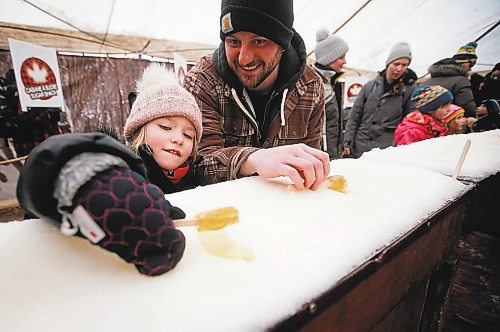 JOHN WOODS / WINNIPEG FREE PRESS
Macy Bell and dad Jamie roll their maple taffy on the last day of the Festival du Voyageur Sunday, February 26, 2023. 

Re: macintosh