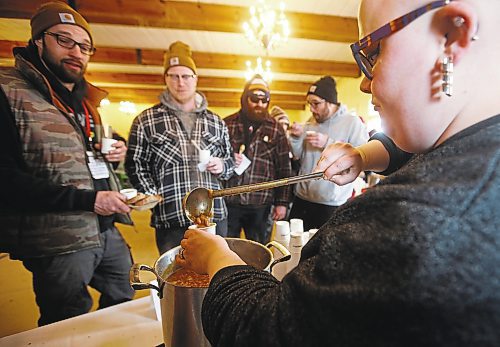 JOHN WOODS / WINNIPEG FREE PRESS
Justin Fillion, from left, Marc-Andre Habeck, Pierre Landry and Jean Fillion wait patiently for Ali Simpson, sous chef at Nonsuch, to pour some pea soup at the pea soup competition on the last day of the Festival du Voyageur Sunday, February 26, 2023. 

Re: macintosh