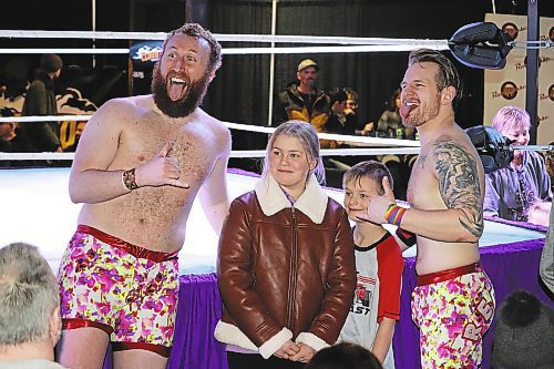 The Cloud 9 Wrestling tag team of Sammy Peppers and Bryce Bentley, known collectively as "Red Hot Summer," pose for photos with members of the audience at The Great Western Roadhouse following their Saturday evening match against The Cannon Corporation. (Kyle Darbyson/The Brandon Sun)  
