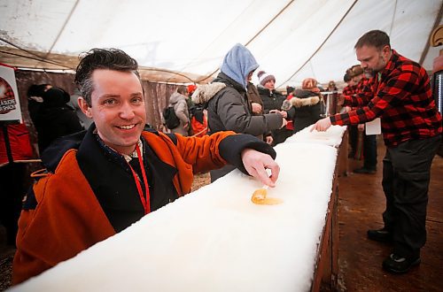 JOHN WOODS / WINNIPEG FREE PRESS
Darrel Nadeau, executive director of Festival du Voyageur, rolls his maple taffy on the last day of the festival Sunday, February 26, 2023. 

Re: macintosh