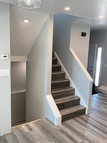 Marc LaBossiere / Winnipeg Free Press
Numerous steps are required to create this finished staircase sheathed in vinyl plank that matches the newly installed flooring throughout.