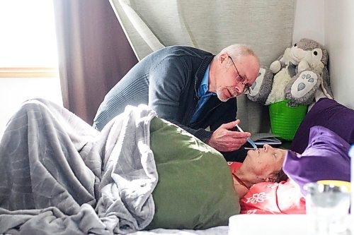 MIKAELA MACKENZIE / WINNIPEG FREE PRESS

Eric De Schepper cares (drips water into her mouth using a syringe) for his common-law wife, Katherine Ellis, who has pancreatic cancer and has opted for palliative care in Winnipeg on Friday, Feb. 17, 2023. He feels the health care system has failed them, as it took him going to the media to get any support in terms of home care workers. For Kevin story.

Winnipeg Free Press 2023.