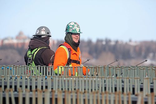 A construction worker grins at the camera while working on top of recently installed metal beams that span the new section of the Daly Overpass. (Matt Goerzen/The Brandon Sun)
