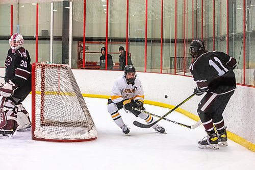 MIKAELA MACKENZIE / WINNIPEG FREE PRESS

Garden City High School player Colson Smith (21) angles for the puck in a game against St. Paul&#x573; High School at Seven Oaks Complex in Winnipeg on Wednesday, March 1, 2023. For Josh story.

Winnipeg Free Press 2023.