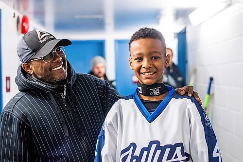 MIKAELA MACKENZIE / WINNIPEG FREE PRESS

Mikli Gemechu, center on the U13 WJHA hockey team, poses for a photo with his dad Abu Gemechu before a game at the Osborne Recreation Centre in Winnipeg on Wednesday, March 1, 2023. He was born in Winnipeg, two years after his family arrived in Canada from Ethiopia, and learned to play hockey thanks to the folks at Winnipeg Newcomer Sport Academy. 
For AV Kitching story.

Winnipeg Free Press 2023.