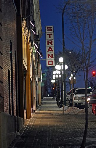Street lights illuminate the sidewalk in front of the aging Strand Theatre, before it's demolition in 2018. (Matt Goerzen/The Brandon Sun)