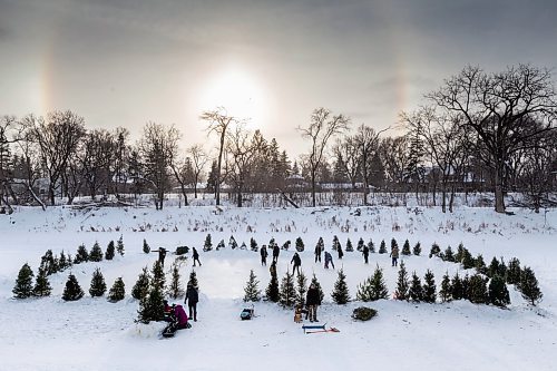 Daniel Crump / Winnipeg Free Press. People skate on a rink cleared on a section of the Assiniboine River in Winnipeg&#x573; Wolseley neighbourhood on Saturday afternoon as ice crystals in the atmosphere cause the formation of sundogs. January 15, 2022.
