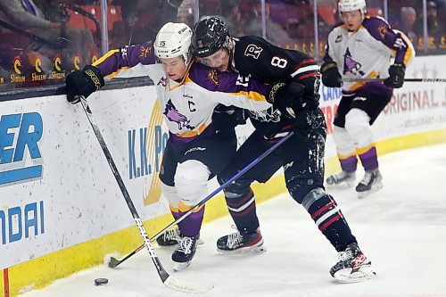 Brandon's Nolan Ritchie jostles for the puck with Jace Weir of the Red Deer Rebels. (Tim Smith/The Brandon Sun)