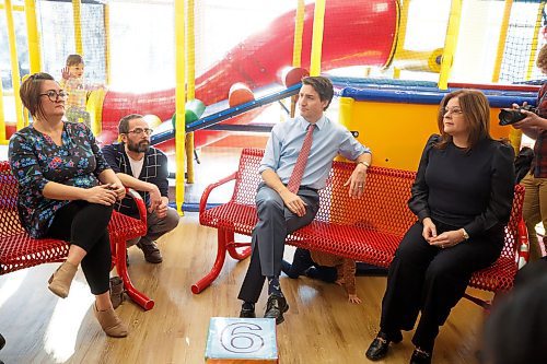 MIKE DEAL / WINNIPEG FREE PRESS
A child crawls under Prime Minister, Justin Trudeau, and the Premier of Manitoba, Heather Stefanson, while they chat with parents at the YMCA on Fermor prior to making an announcement that Manitoba will achieve an average of $10-a-day regulated child care on April 2, 2023 &#x2013; three years ahead of the national target.
230303 - Friday, March 03, 2023.