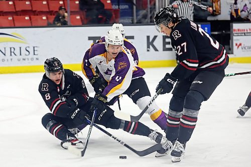 03032023
Rylen Roersma #11 of the Brandon Wheat Kings tries to slip the puck between Jace Weir #8 and Mats Lindgren #27 of the Red Deer Rebels during WHL action at Westoba Place on Friday evening. 
(Tim Smith/The Brandon Sun)