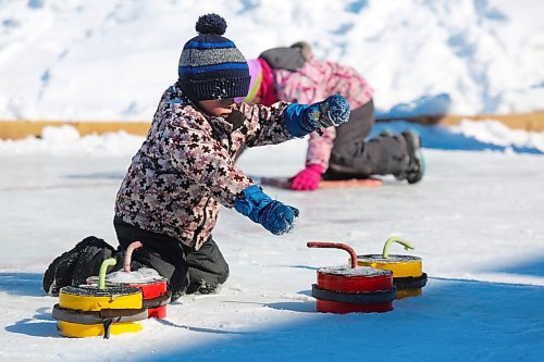 Three-year-old Jonah Dubnick showcases his unique crokicurling technique outside Brandon's Community Sportsplex during Saturday's Winter Fest celebration in the city's north end. (Kyle Darbyson/The Brandon Sun)