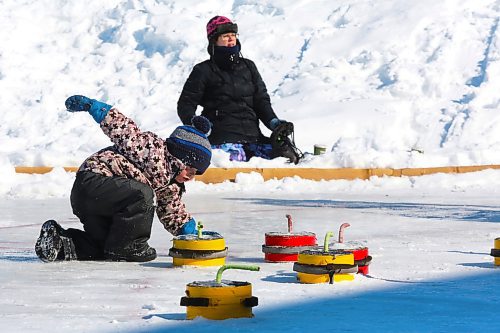 Three-year-old Jonah Dubnick showcases his unique crokicurling technique outside Brandon's Community Sportsplex during Saturday's Winter Fest celebration in the city's north end. (Kyle Darbyson/The Brandon Sun)