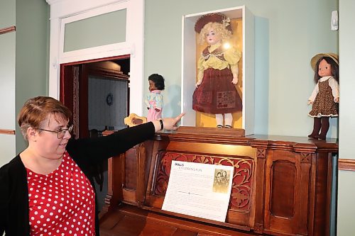 Curator Eileen Trott highlights some vintage dolls that are on display at the Daly House Museum Saturday afternoon. These dolls are a part of the museum's “Collected, Gifted & Saved! Sharing Local History" exhibit. (Kyle Darbyson/The Brandon Sun)