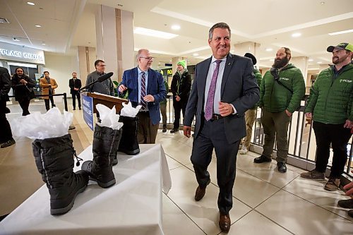 Mike Deal / Winnipeg Free Press
During a media event held at CityPlace Shopping Centre Monday morning Finance Minister Cliff Cullen, rather than purchase a new pair of shoes prior to budget day, as is tradition, instead has two pairs of winter boots that he is giving to members of the Downtown Community Safety Partnership (DCSP) to distribute to program participants in downtown Winnipeg who do not have proper winter footwear. 
230306 - Monday, March 6, 2023