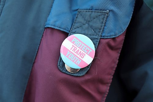 06032022
An attendee at the Stop the BS in the U.S. rally at Brandon University against bans of drag, gender affirming care and gender studies programs in U.S. states wears a button that reads protect trans youth. The rally was organized by Mandy Swidersky, a gender and woman studies student at Brandon University, and featured multiple speakers. (Tim Smith/The Brandon Sun)
