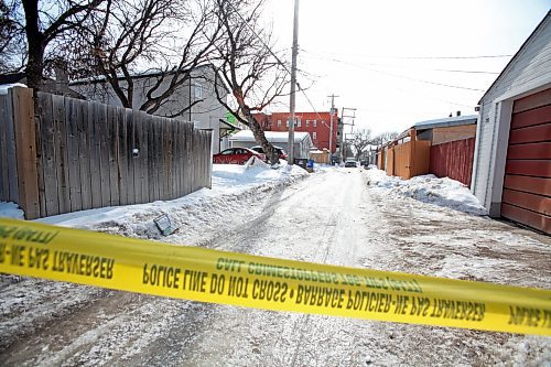 Caution tape blocks off the lane of Beverley and Toronto streets, between Ellice and St. Matthews avenues, on Tuesday. Two women were found with gunshot wounds at about 6 a.m.; one had died by the time police arrived. ERIK PINDERA/WINNIPEG FREE PRESS