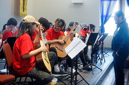 MIKE DEAL / WINNIPEG FREE PRESS
Jerimiah Knott (wearing a headband) with the Wasagamack First Nation School Guitar Orchestra performs Tuesday morning at the Fort Garry United Church, 800 Point Road, during the Winnipeg Music Festival.
The last time Wasagamack First Nation School Guitar Orchestra participated (2022) they received the Lieutenant Governor&#x2019;s Award for the most outstanding performance of the festival.
230307 - Tuesday, March 07, 2023.