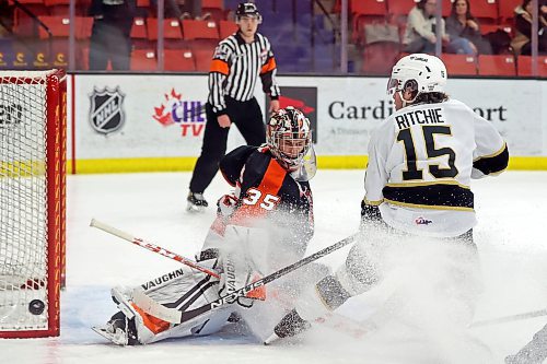 08032022
Netminder Beckett Langkow #35 of the Medicine Hat Tigers deflects a shot on net by Nolan Ritchie #15 of the Brandon Wheat Kings during WHL action at Westoba Place on Wednesday evening. 
(Tim Smith/The Brandon Sun)