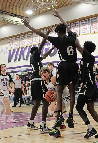 Vincent Massey Vikings Justin Sharp is swarmed by three Vincent Massey Trojans during the first round of AAAA varsity boys' basketball provincials on Thursday. (Thomas Friesen/The Brandon Sun)