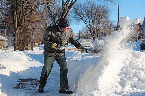 Brandon resident Murray Starkell clears a sidewalk outside his home on Sunday morning after a major blizzard blanketed the city in snow throughout Saturday. (Kyle Darbyson/The Brandon Sun)
