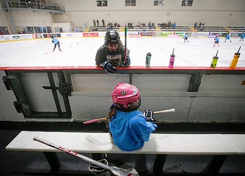 JOHN WOODS / WINNIPEG FREE PRESS
Kimmy Davidson, volunteer from the U of MB Bison women's hockey team, encourages MacKenzie to hit the ice at Girls Hockeyfest at Hockey For All Centre Sunday, March 12, 2023. 

Re: ?
