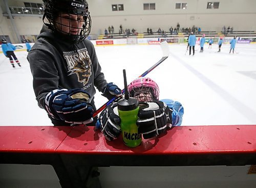 JOHN WOODS / WINNIPEG FREE PRESS
Kimmy Davidson, volunteer from the U of MB Bison women's hockey team, is there to help as MacKenzie reaches for her water bottle at Girls Hockeyfest at Hockey For All Centre Sunday, March 12, 2023. 

Re: ?