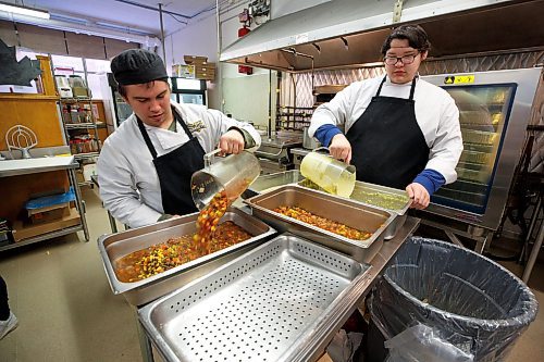 MIKE DEAL / WINNIPEG FREE PRESS
Brennan Paszko (left) and CJ Courchene (right) Grade 11 students in the Tec Voc Culinary Arts program, prep soups.
Child Nutrition Council of Manitoba launches its annual Stone Soup fundraiser at Tec Voc on Monday. Participating local restaurants will be donating a portion of soup sales to the cause, which has seen an increase in demand for food programs from school groups this year.
See Eva Wasney story
230313 - Monday, March 13, 2023.