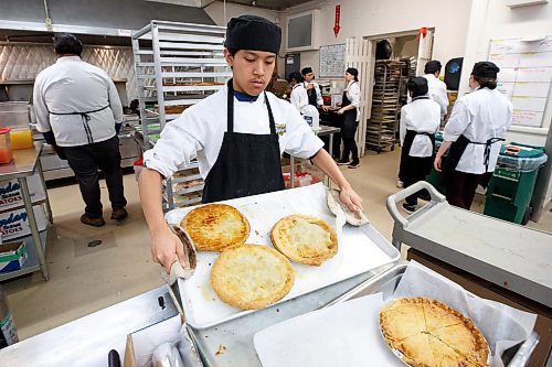 MIKE DEAL / WINNIPEG FREE PRESS
Alexander De Lima a Grade 10 Tec Voc student in the Culinary Arts program with some freshly baked meat pies.
Child Nutrition Council of Manitoba launches its annual Stone Soup fundraiser at Tec Voc on Monday. Participating local restaurants will be donating a portion of soup sales to the cause, which has seen an increase in demand for food programs from school groups this year.
See Eva Wasney story
230313 - Monday, March 13, 2023.