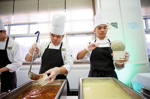 MIKE DEAL / WINNIPEG FREE PRESS
Tec Voc students Lawrence Gallardo (left) and Rhovic Curatcha (right) serve soup during the launch of the Stone Soup fundraiser.
Child Nutrition Council of Manitoba launches its annual Stone Soup fundraiser at Tec Voc on Monday. Participating local restaurants will be donating a portion of soup sales to the cause, which has seen an increase in demand for food programs from school groups this year.
See Eva Wasney story
230313 - Monday, March 13, 2023.