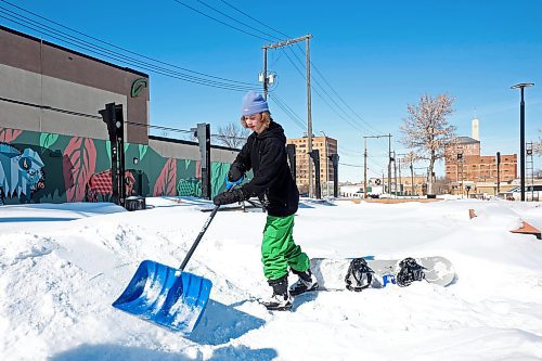 13032023
Caleb Ross packs snow so he can snowboard at the Kristopher Campbell Memorial Skate Plaza on a sunny Monday. (Tim Smith/The Brandon Sun)