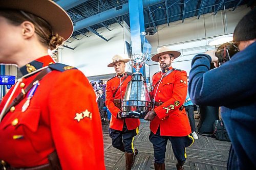 MIKAELA MACKENZIE / WINNIPEG FREE PRESS

RCMP carry the Grey Cup into a press conference at IG Field in Winnipeg on Tuesday, March 14, 2023. For Jeff story.

Winnipeg Free Press 2023.