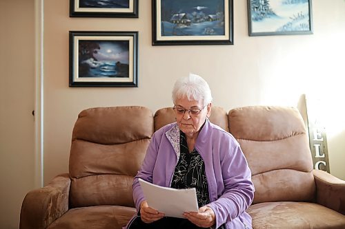 Eleanor Buechler, 79, reads over her notes about her 

an ambulance and air ambulance trip to Winnipeg back in February, while sitting in her home in Brandon on Tuesday. (Tim Smith/The Brandon Sun)